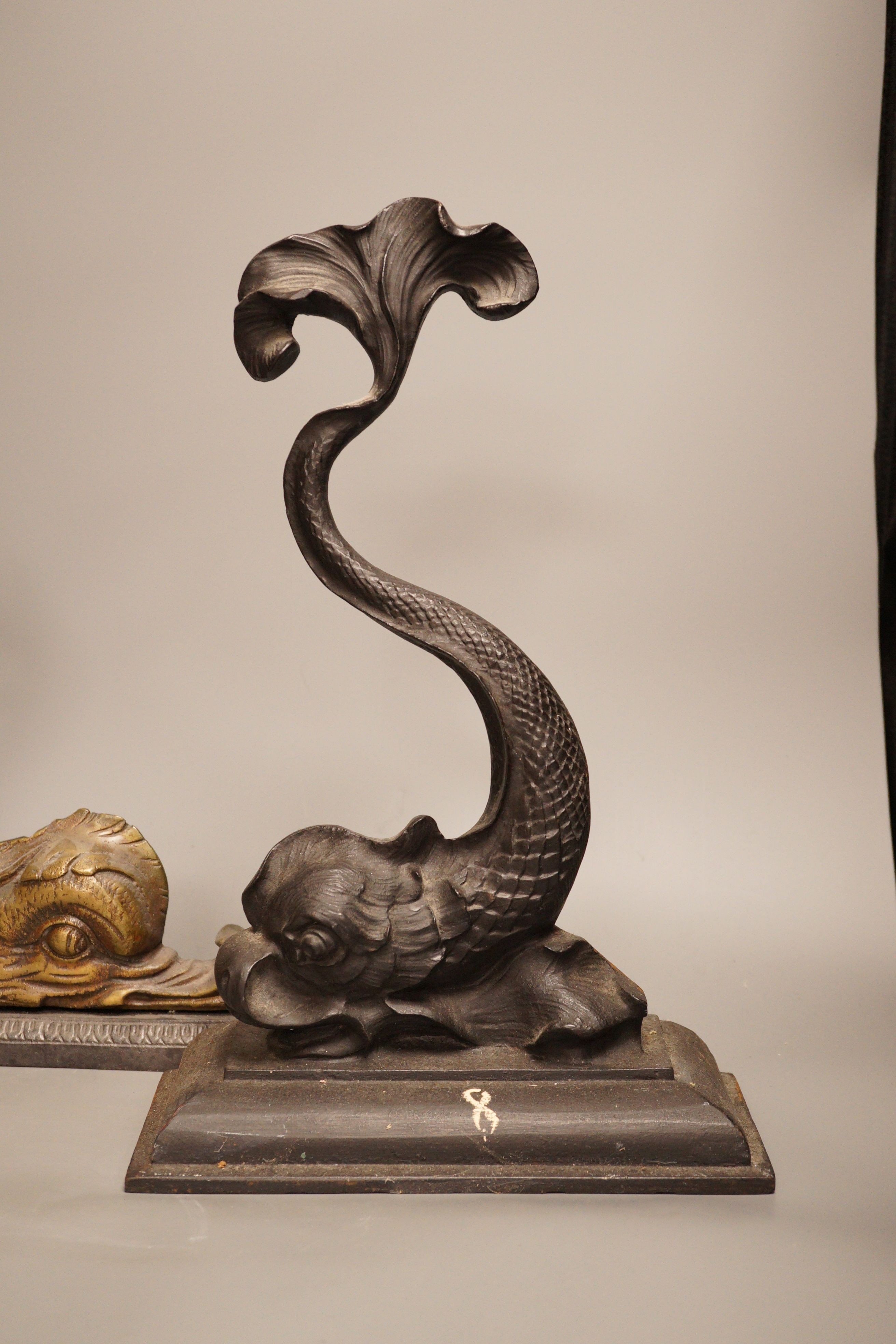 Two cast iron or brass ‘dolphin’ door stops, tallest 38cm